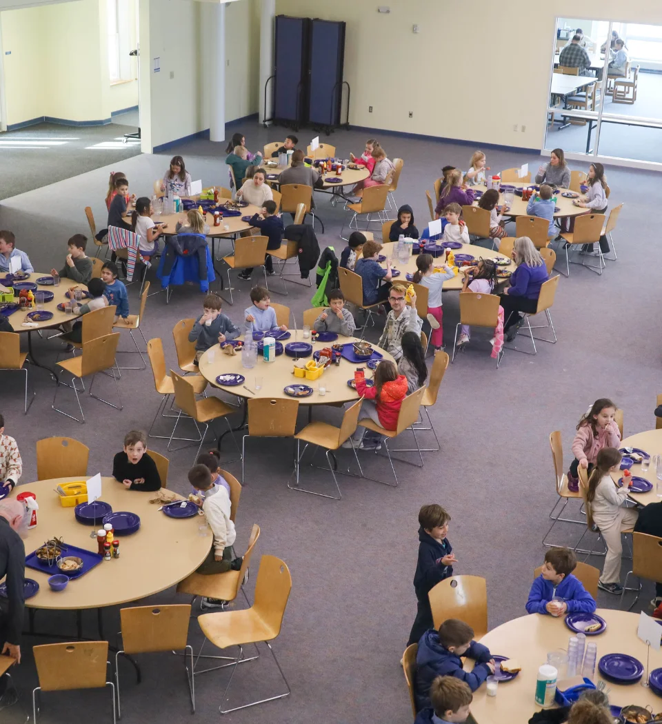 students eating lunch in large dining room