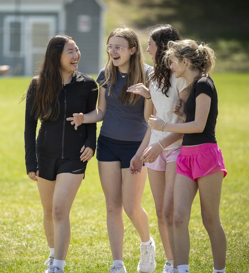 4 students walking together outside
