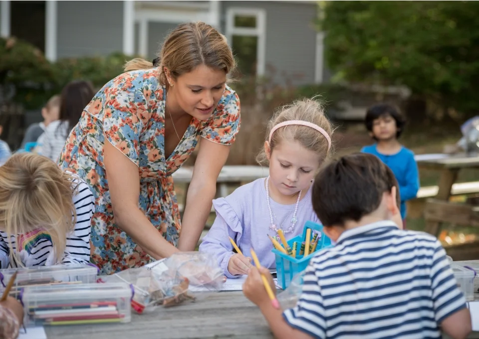 teacher and students doing art outside
