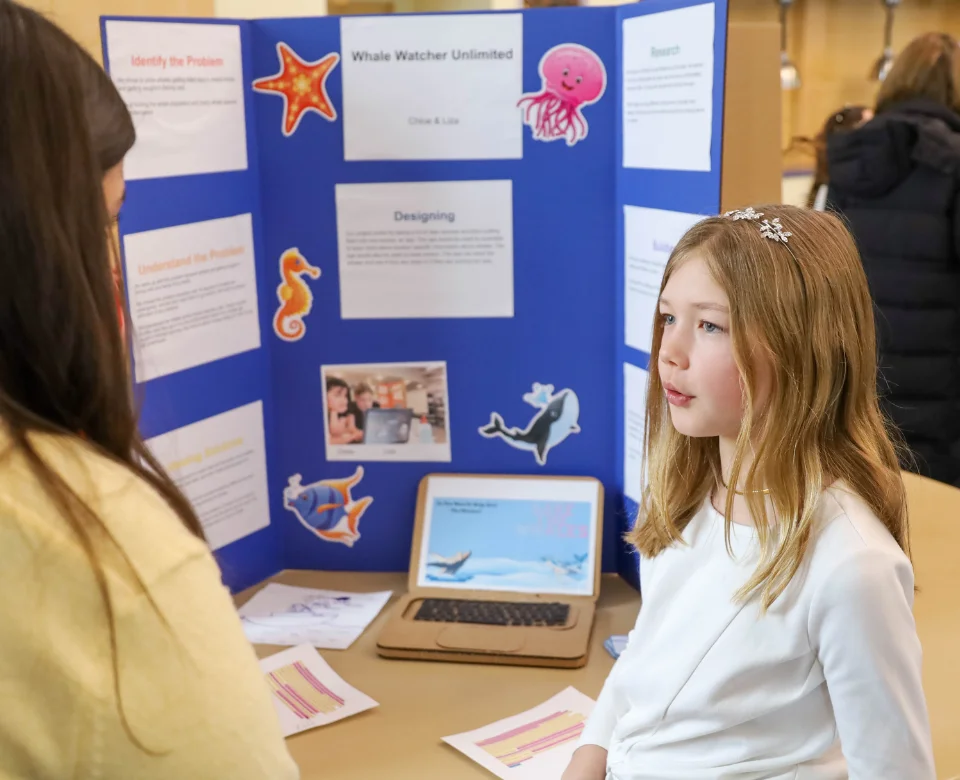 Student presenting to teacher