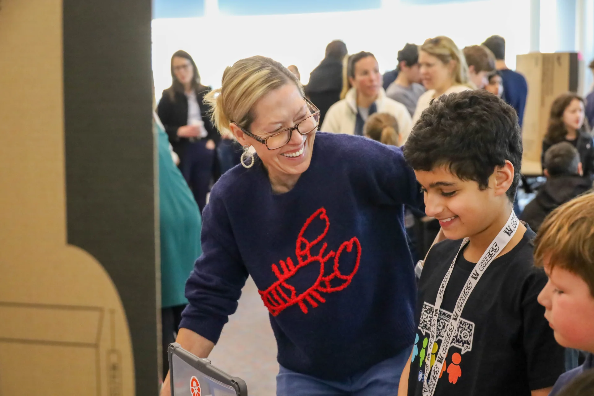 Teacher smiling with student during presentation