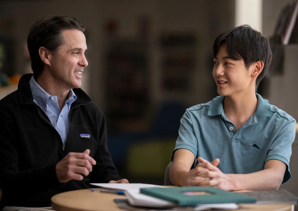 teacher working with a student